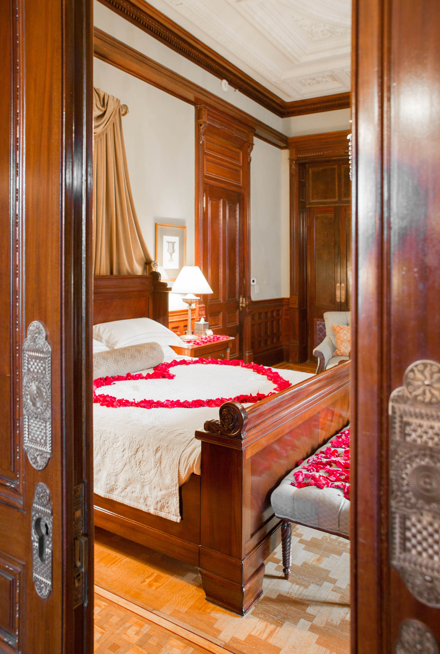 heart made of rose paddles on bed at wentworth mansion