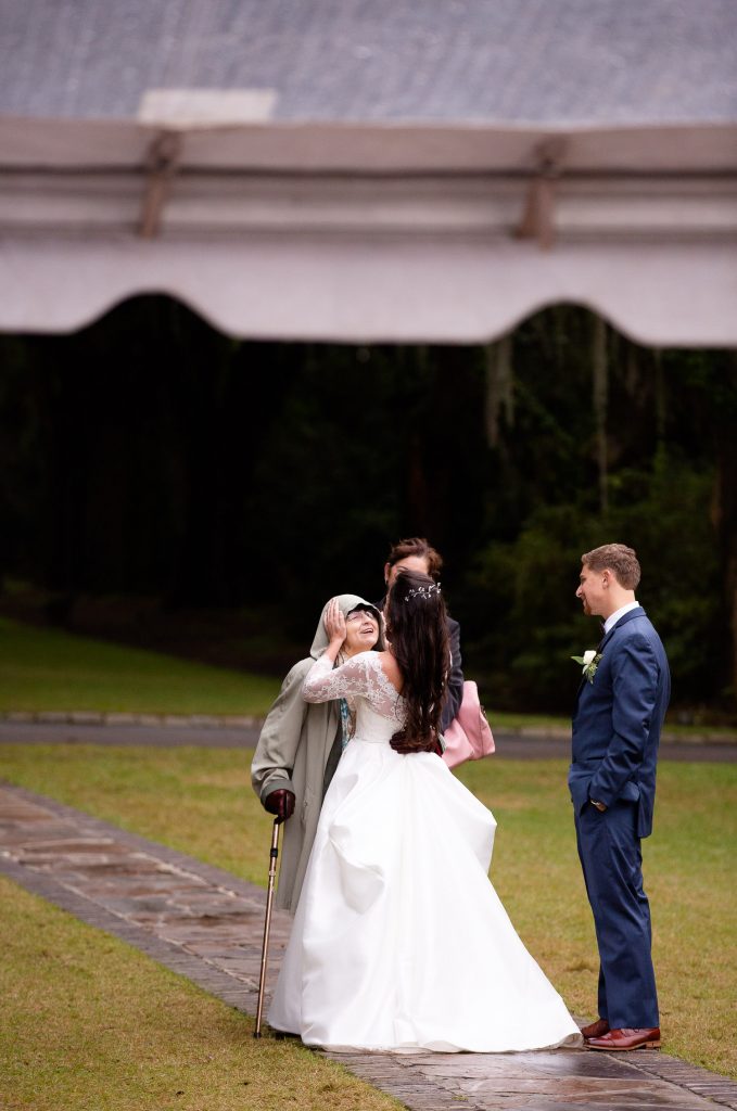 Cute moment during rainy Charleston wedding