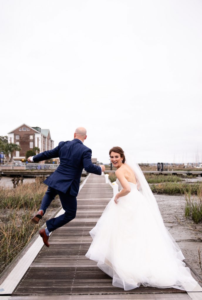 Groom joy jumping at Charleston Yacht Club wedding