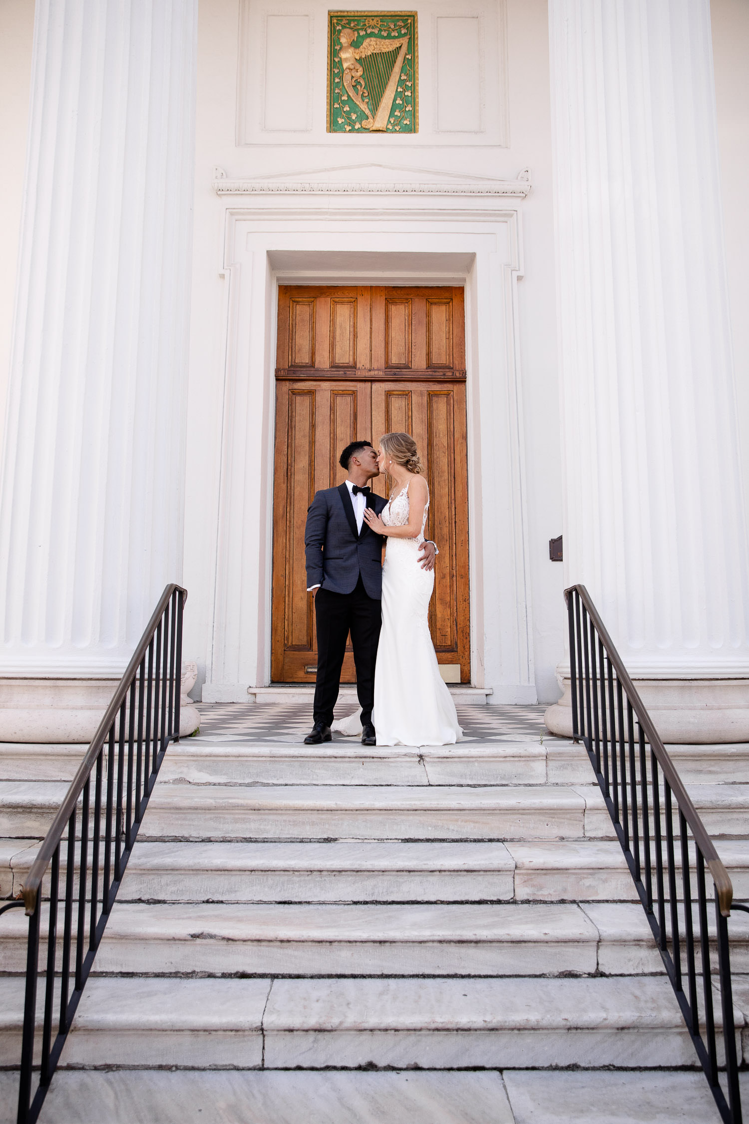 Bride and groom kiss at Hibernian Hall Charleston