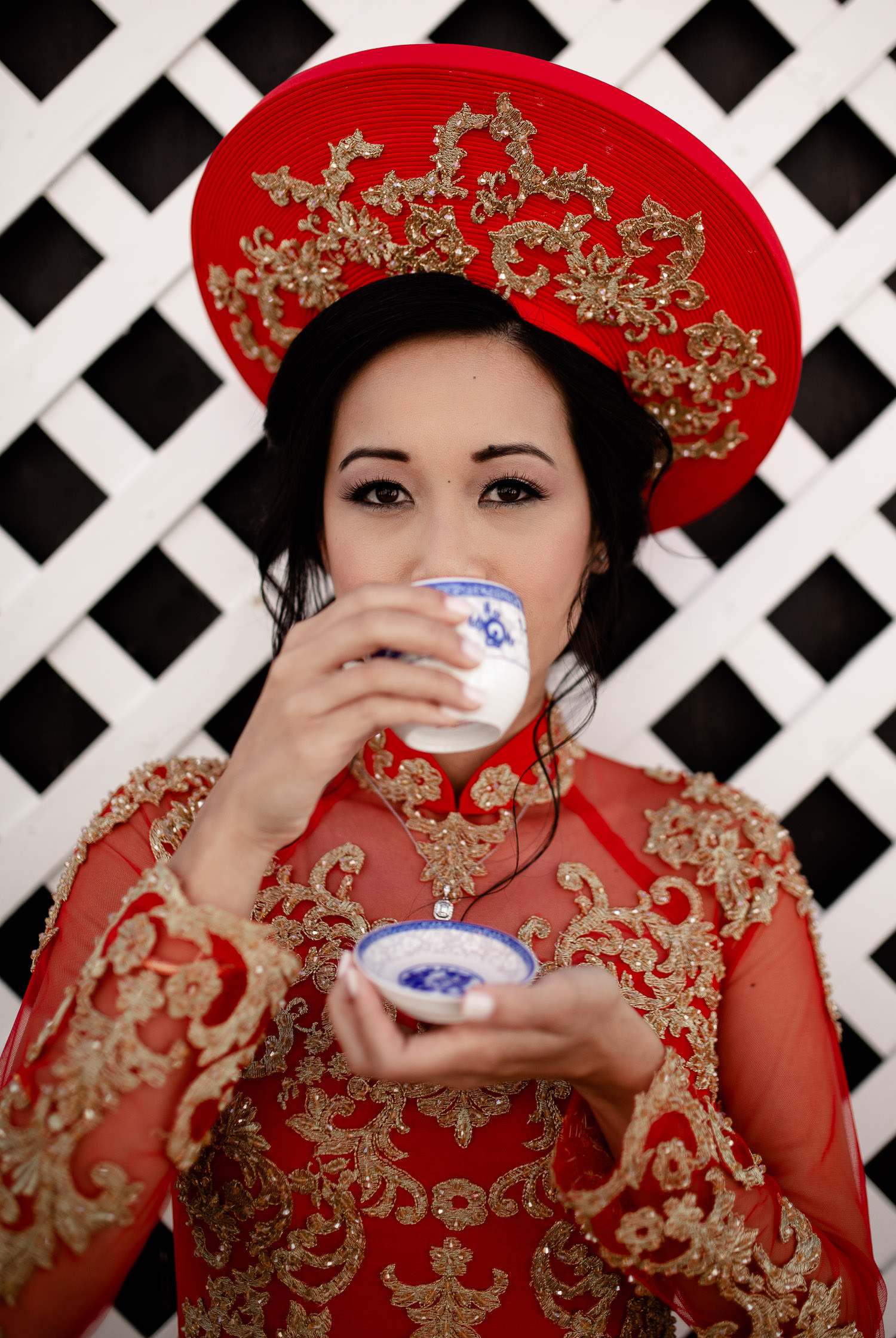Bride drinking tea in traditional Vietnamese wedding dress