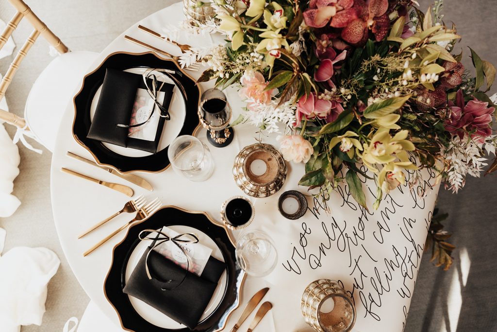 Magnolia Plantation wedding table setup with black and gold theme