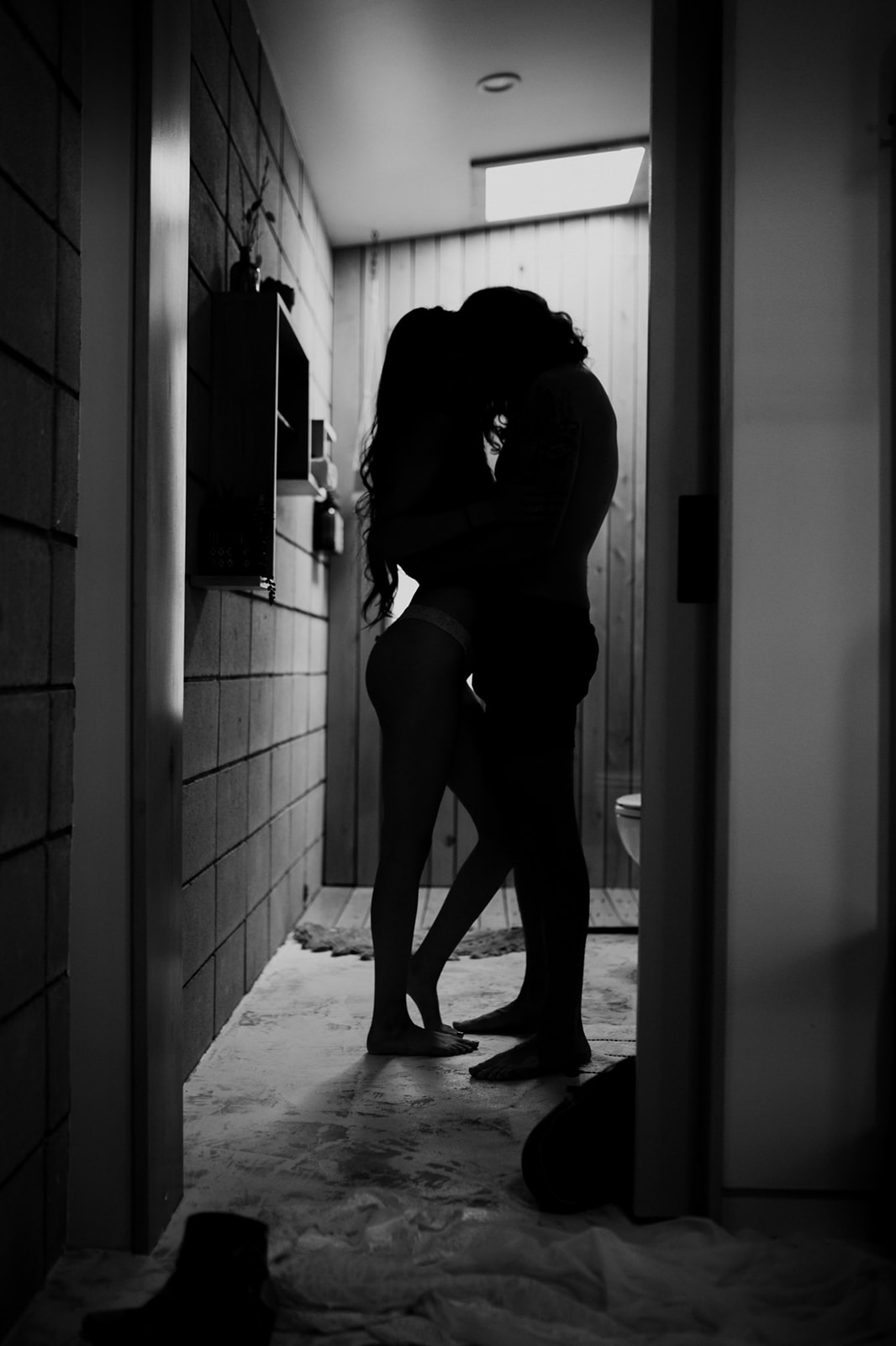 Black and white photo of couple's silhouette during steamy shower engagement photos