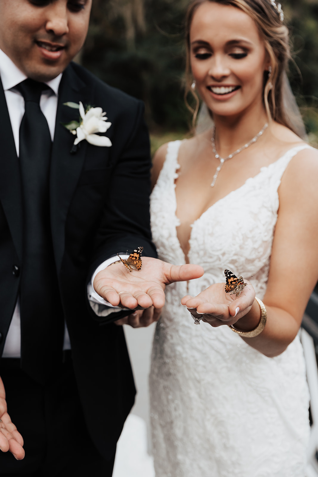 Bride and groom holding butterflies at Magnolia Plantation for release