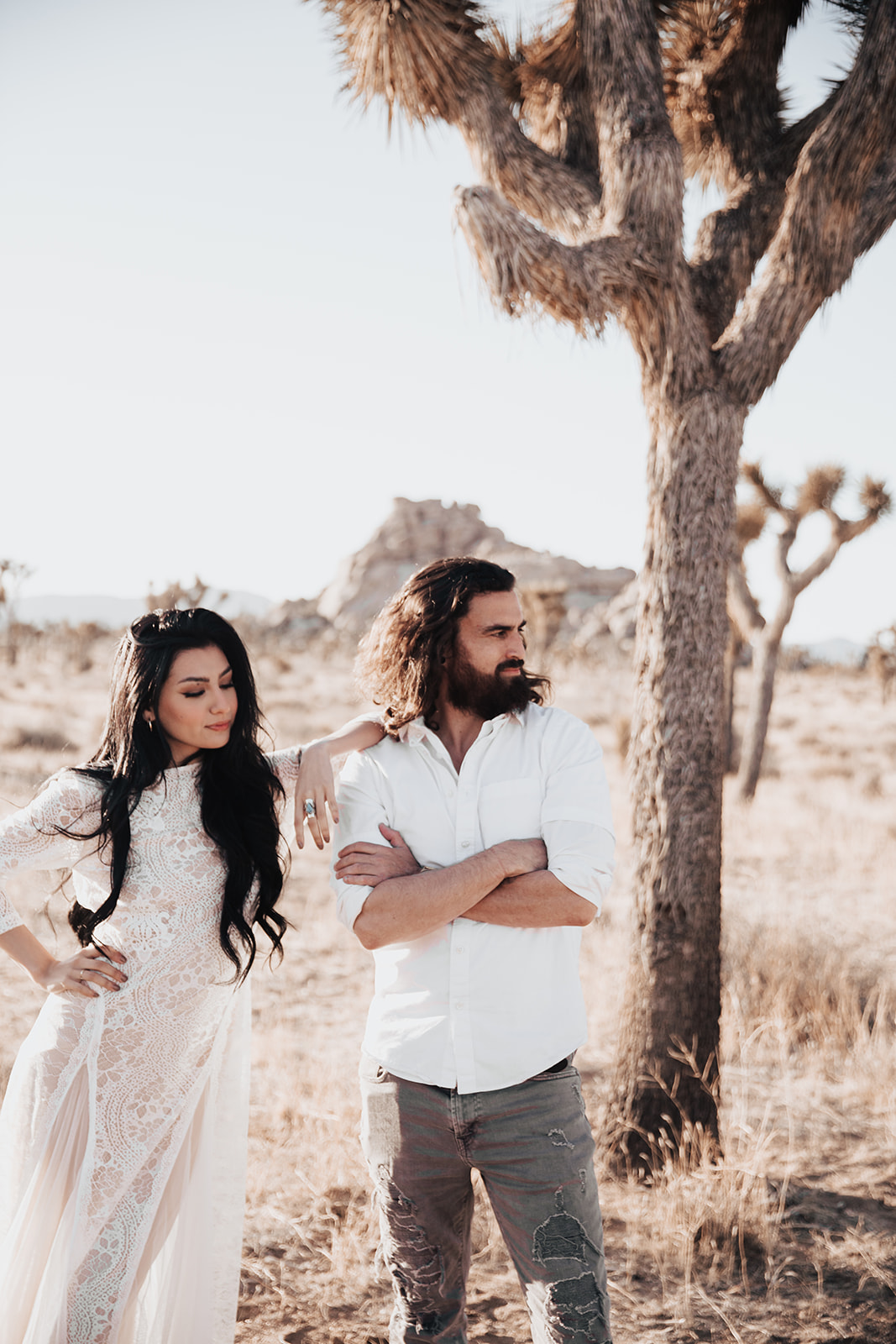 cool and edgy couple standing in Joshua Tree for Engagement photo