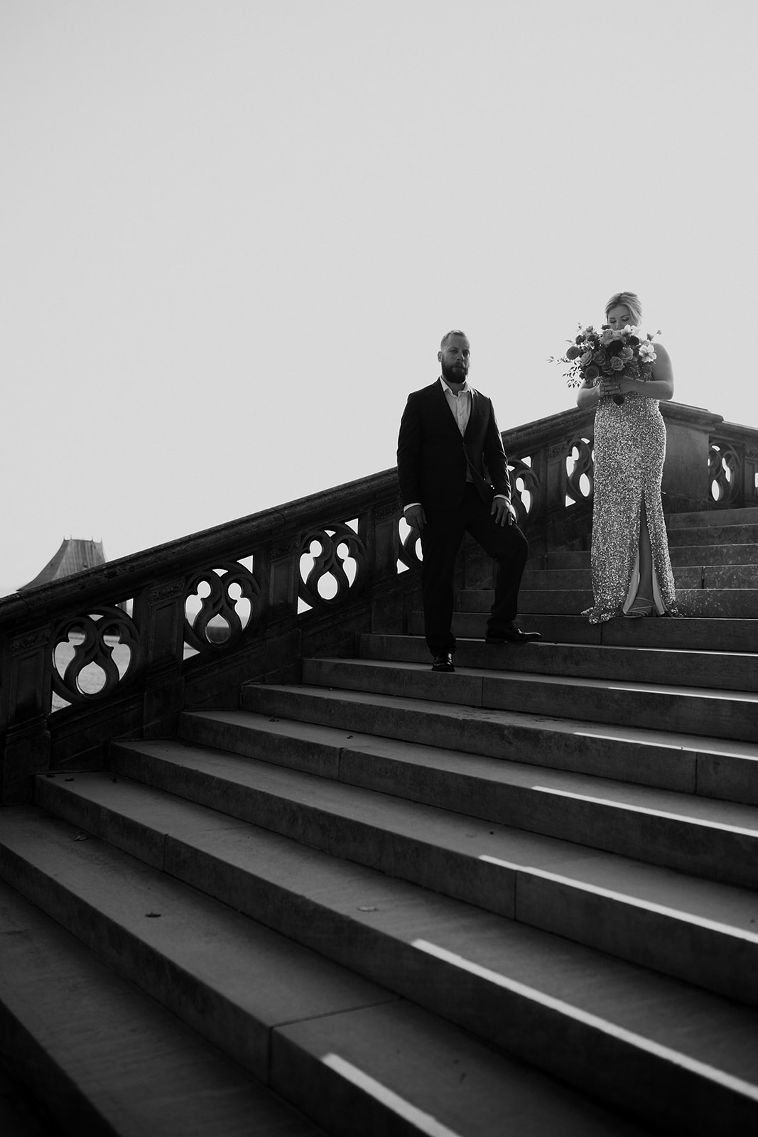 Black and white photo of couple walking down stairways at Biltmore Estate photo session