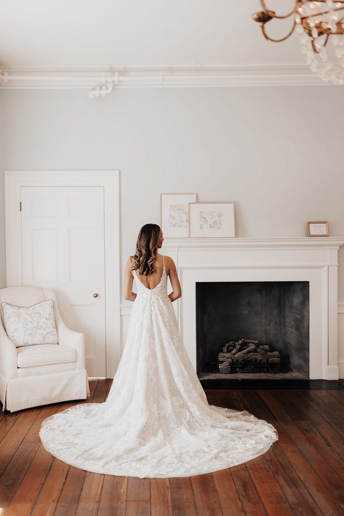 elegant bride in high ceiling room with fire place