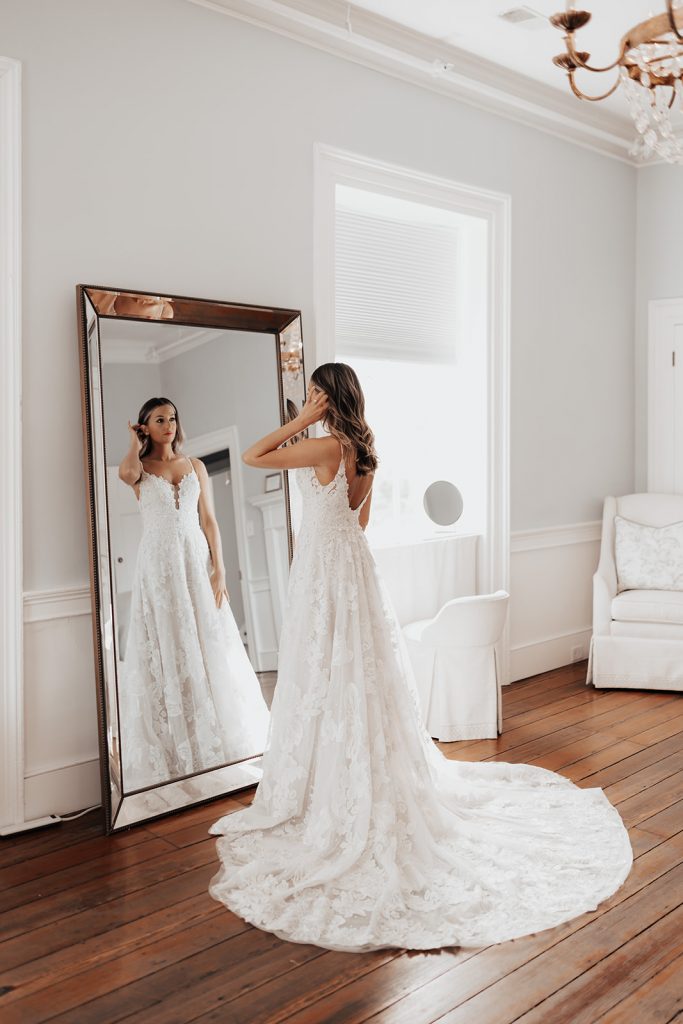 Chic Charleston Bride looking at herself in mirror 
