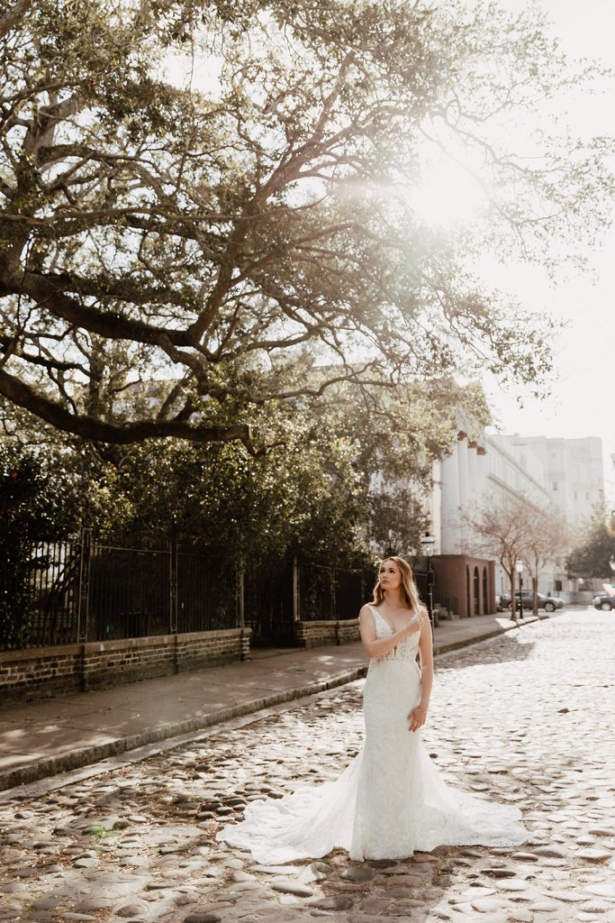 Bride standing on Charleston cobblestone street during bridal session