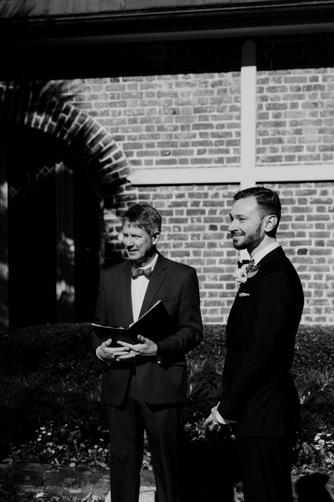 Kevin Kuehmeier from Lowcountry Marriage Officiant and groom waiting looking at bride