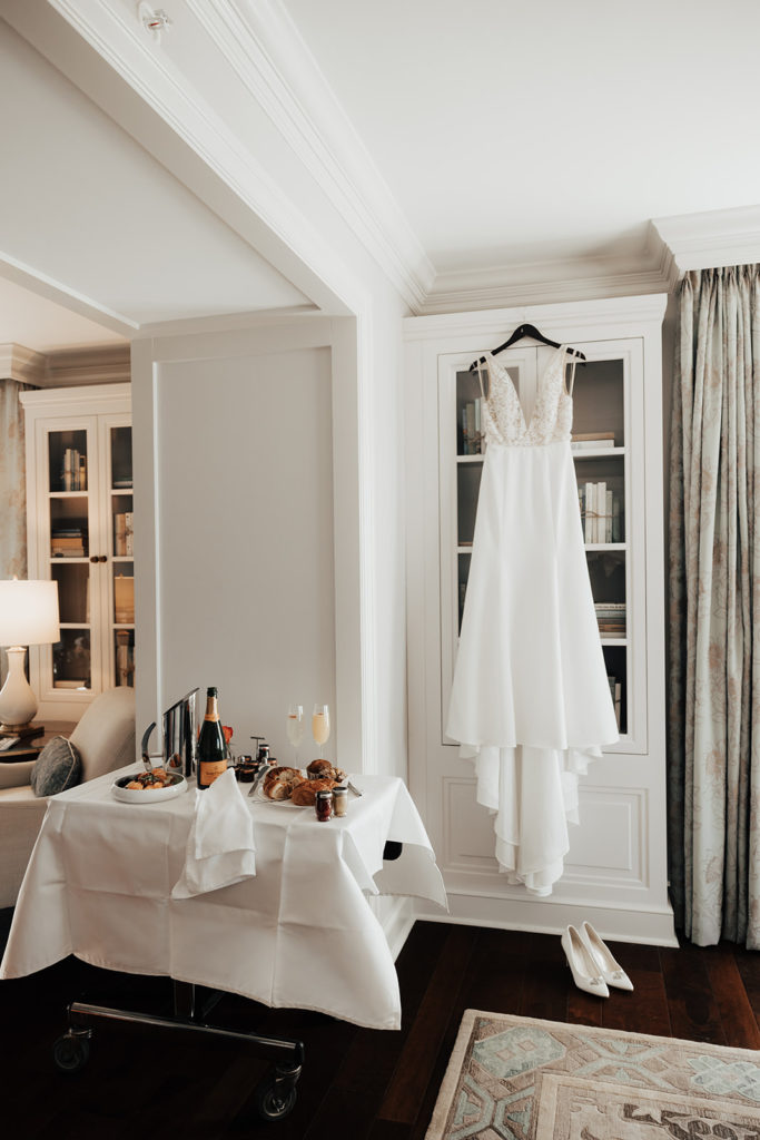 Bridal suite with catering cart and wedding dress at hotel bennett