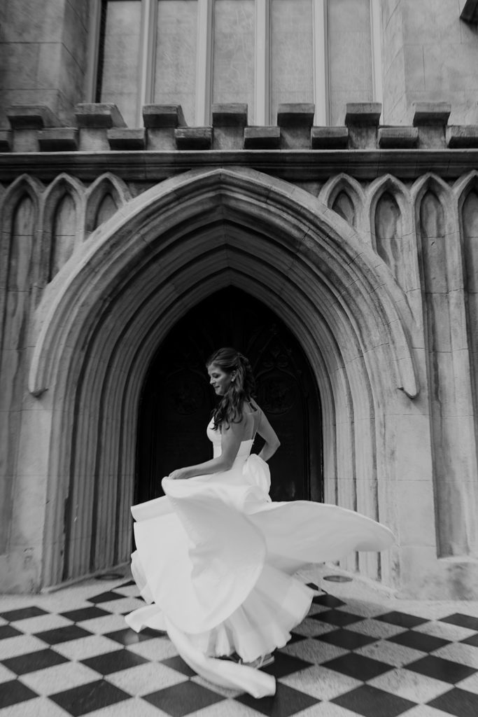 Bride twirling with beautiful dress in front of Grace Church Cathedral