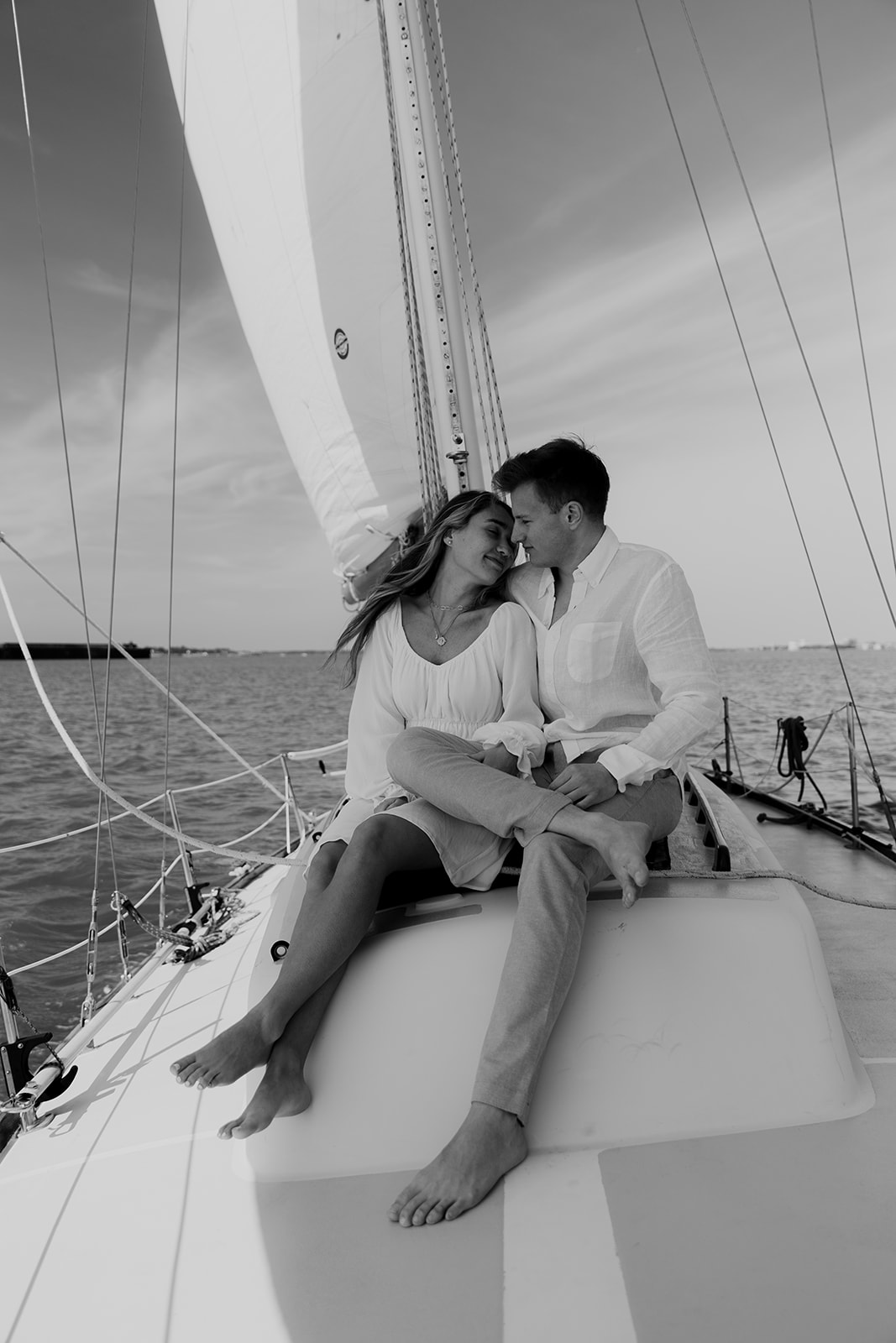 Couple kissing in front of sail