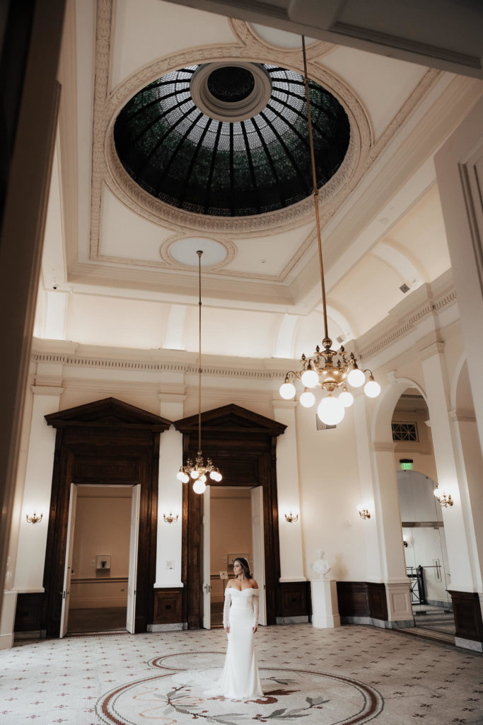 Bride standing in middle of room with high cupola