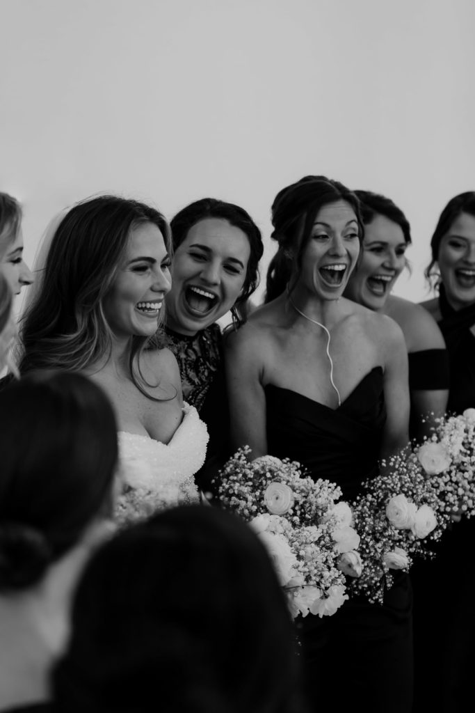 Bride with bridesmaids photographed in black and white before wedding ceremony at Gibbes museum