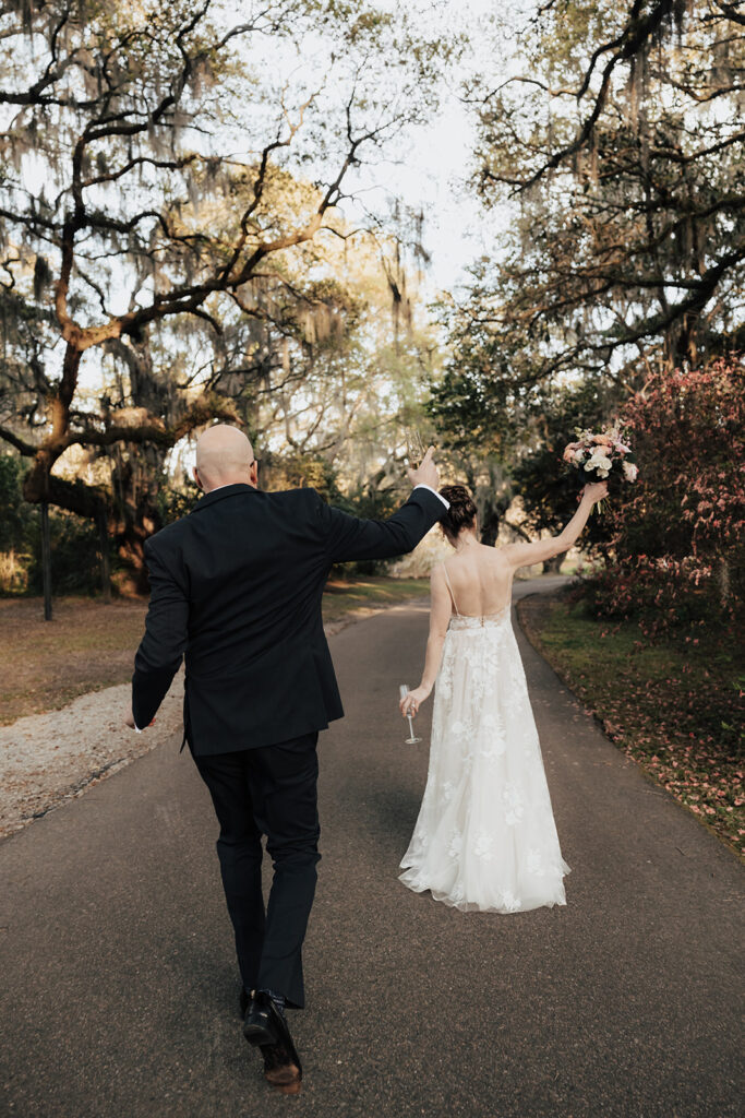 Bride and groom celebrating during theur Legare Waring House wedding