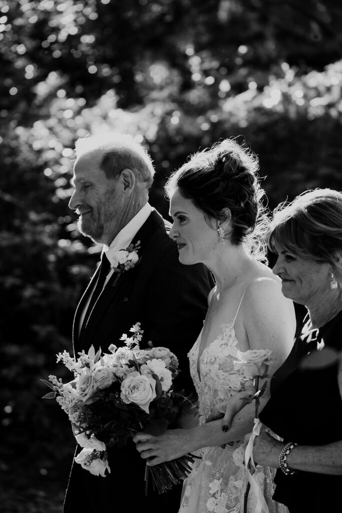 Bride walking down the aisle with both parents