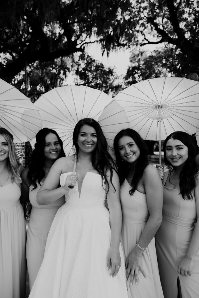 Bride with bridemaids holding parasols at Boone Hall plantation wedding