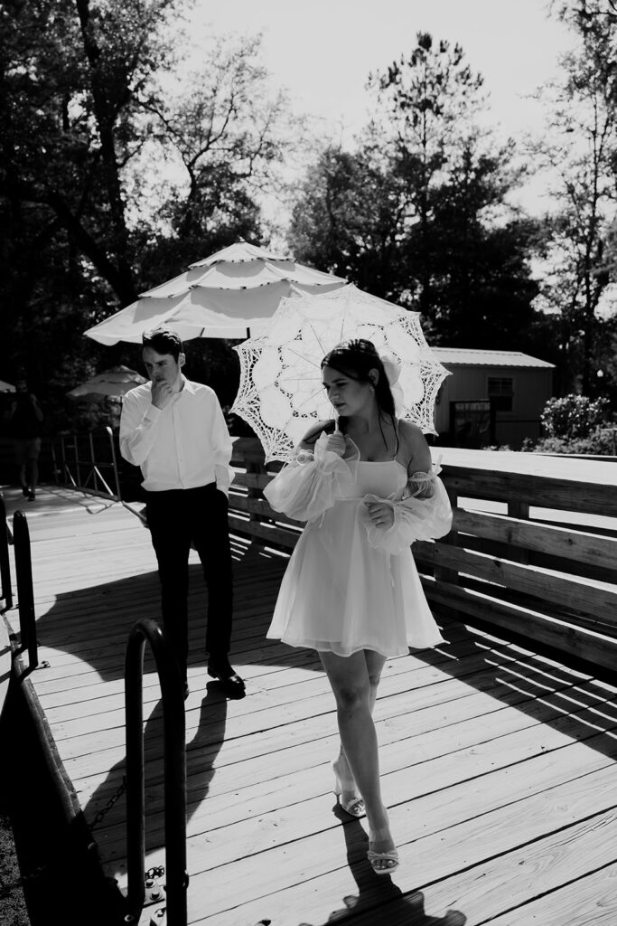 Couple walking to boat to take Cypress garden engagement photos
