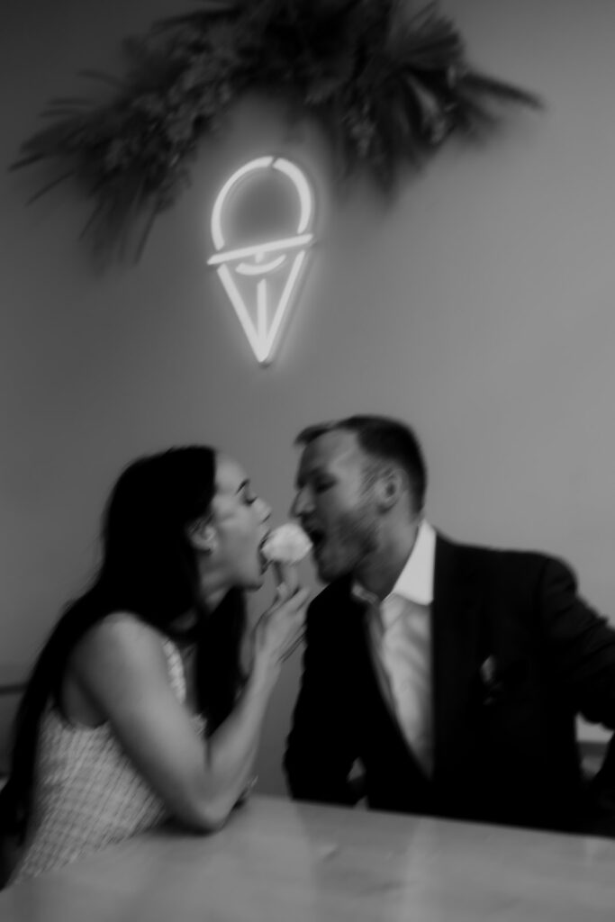 Couple sharing ice cream during engagement photo session