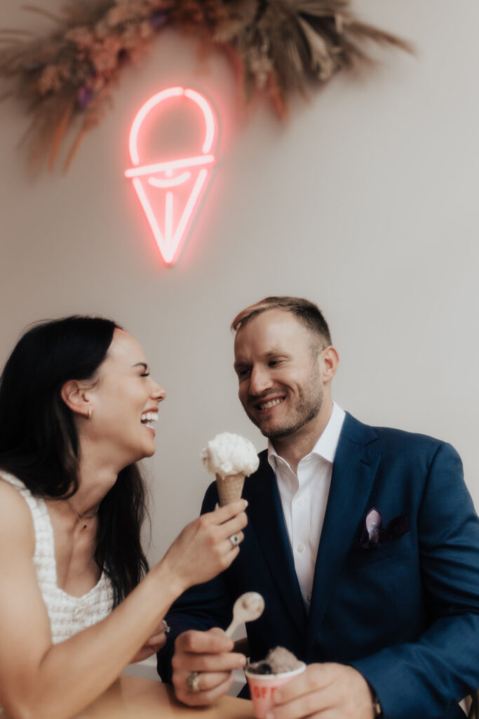 Neon sign at ice cream parlor engagement photos