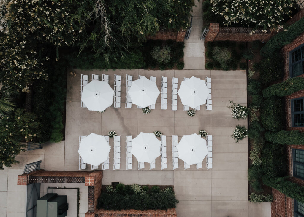 arial photo of Cedar Room Wedding ceremony setup. Parasols from above