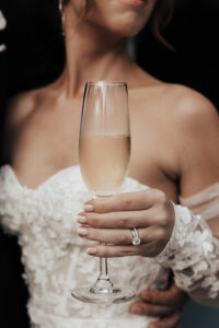 Bride holding glass of champagne at Cannon Green wedding