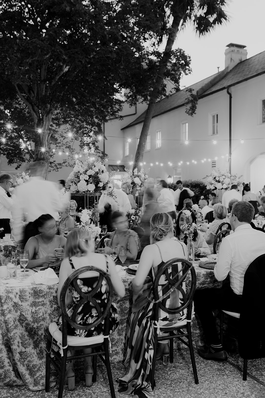 Black and white photo of outdoor wedding reception at William Aiken House