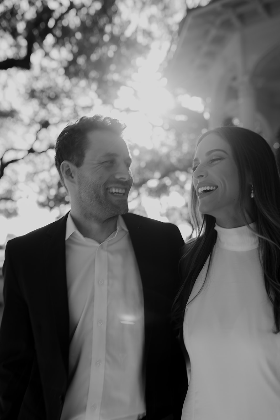 Black and white photo of couple laughing during Charleston Engagement photo Session