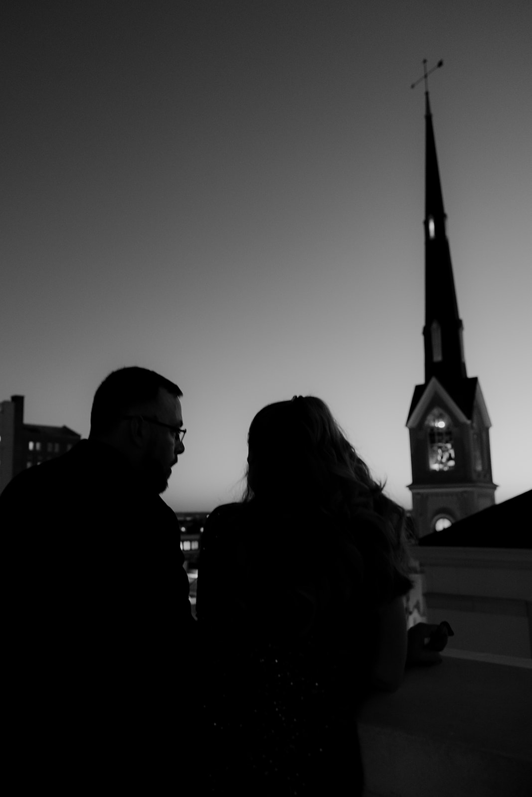 Black and white silhouette of wedding guest at sunset photographed on Hotel Bennett rooftop wedding