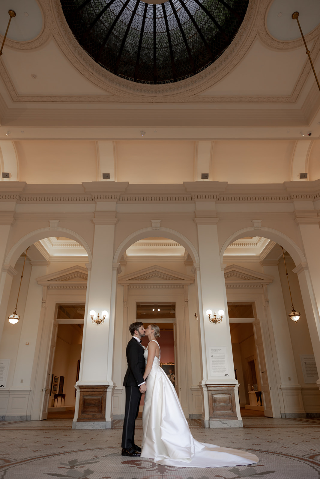 Bride and groom kiss at Gibbes Museum Rotonda after first look. gibbes museum wedding