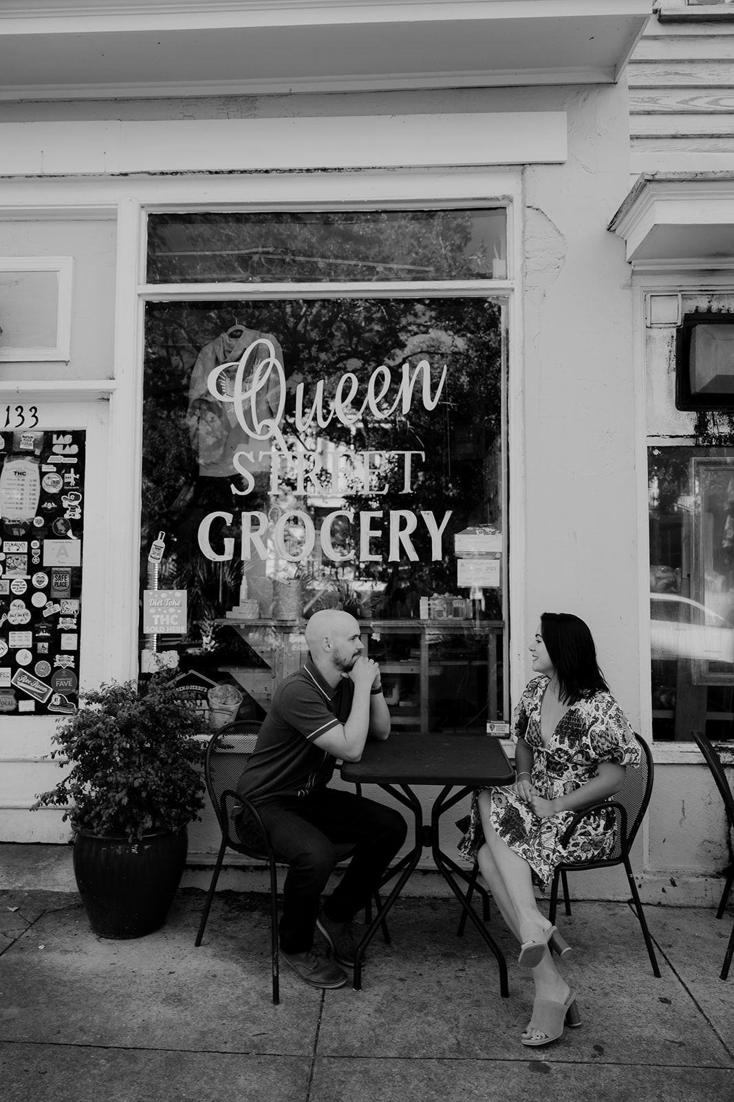 Couple sitting outside Queen Street Grocery for engagement
