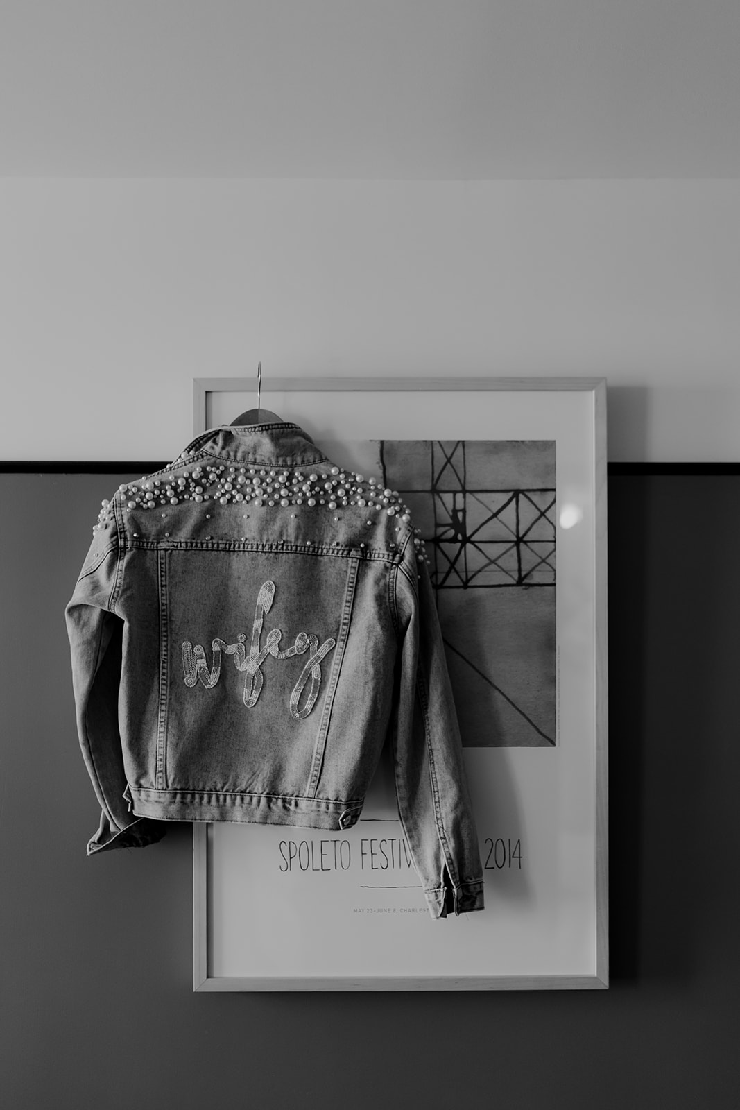 Bridal jeans jacket with wifey lettering hung at Spoletto poster at Hotel Emeline