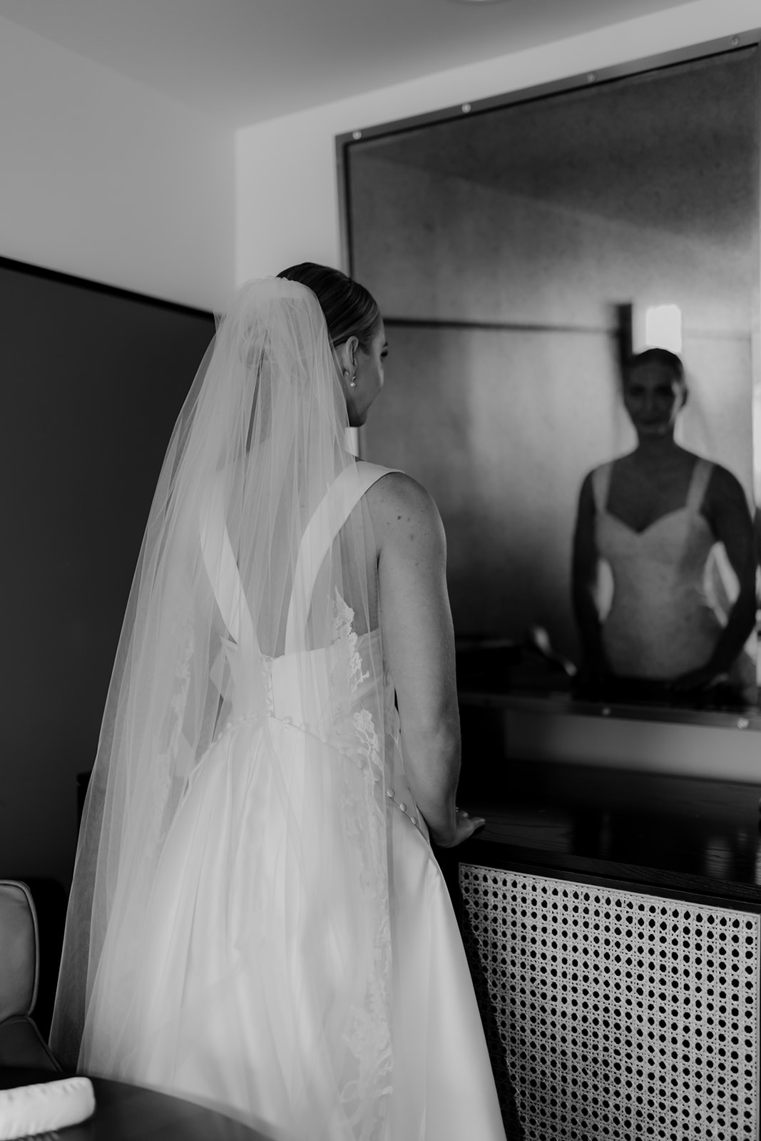 Bride looking into mirror before wedding ceremony at Hotel Emeline