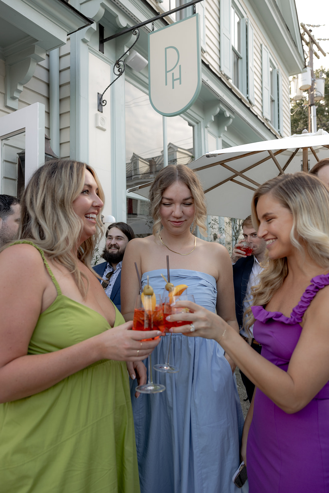 Guests enjoying cocktails in front of The Post House for wedding rehearsal