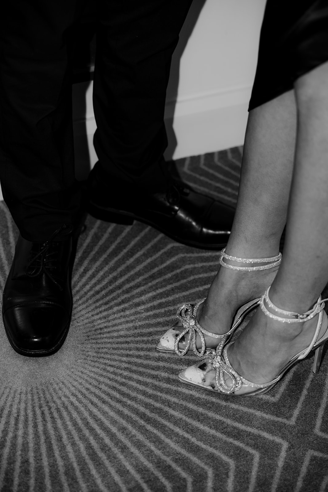 Photo of man and woman shoes on vendue hotel carpet
