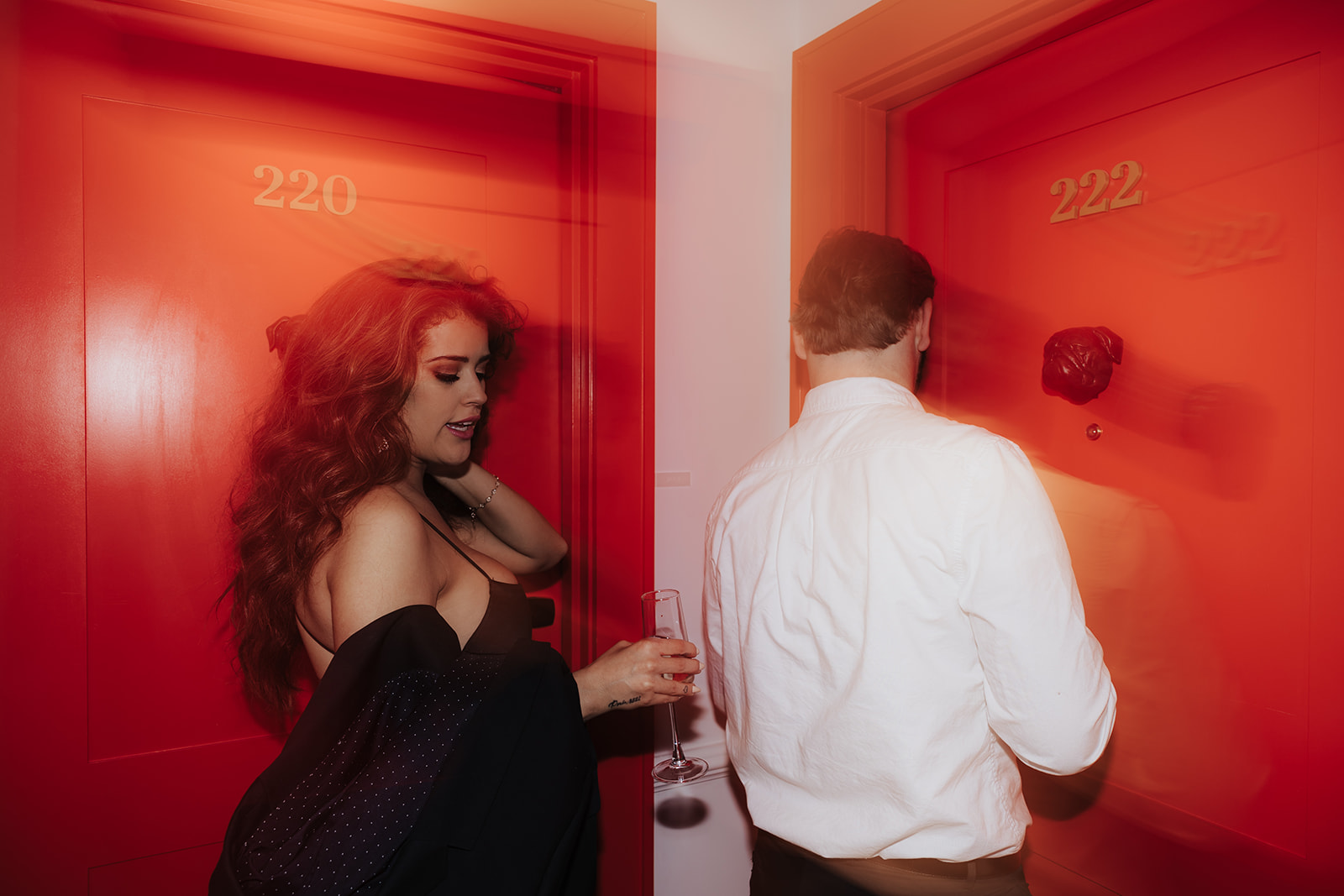 Hotel Engagement Session. Artsy phot of couple opening room door at the vendue in Charleston