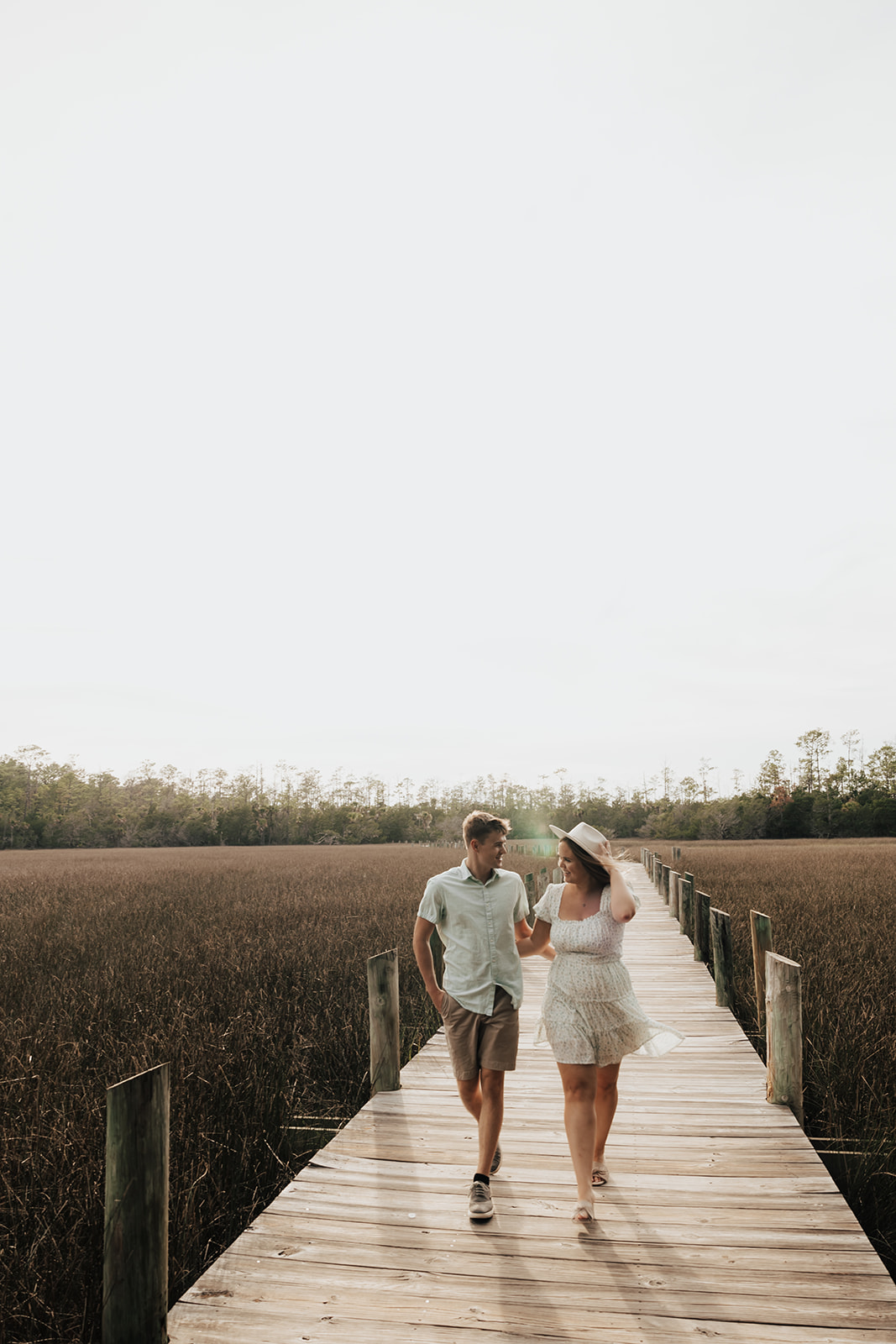 Couple walking at Palmetto Islands County Park for engagment photos