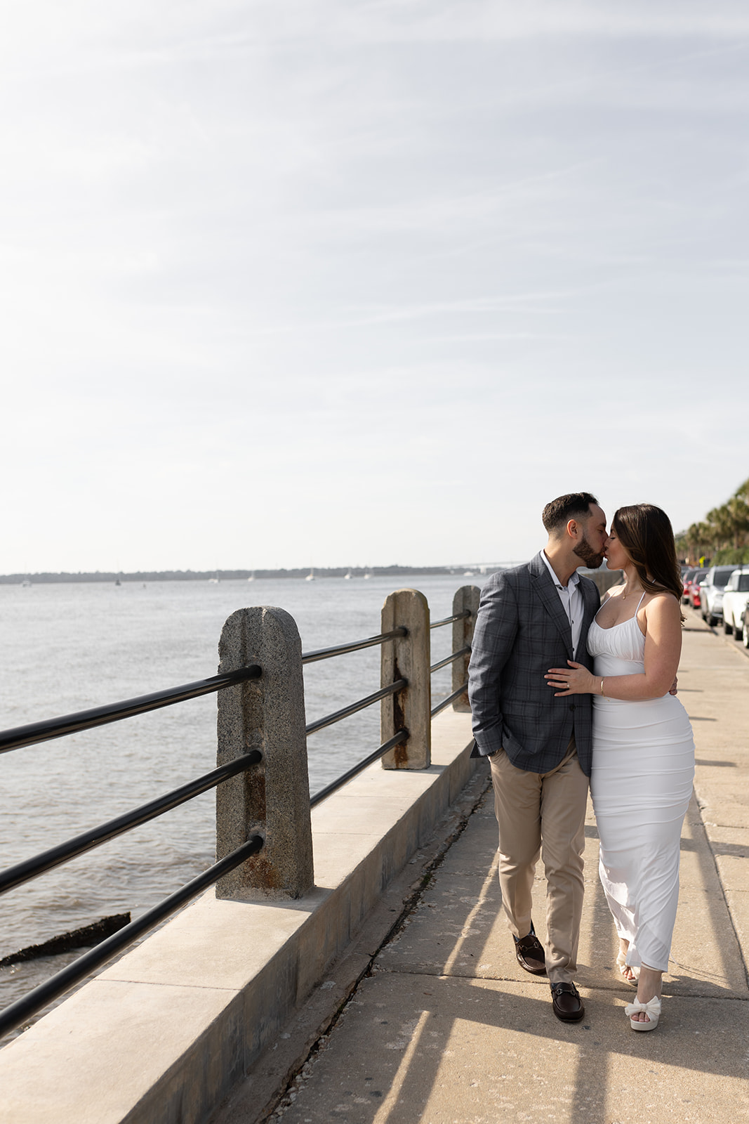Couple walking and kissing at Charleston Battery Engagement
