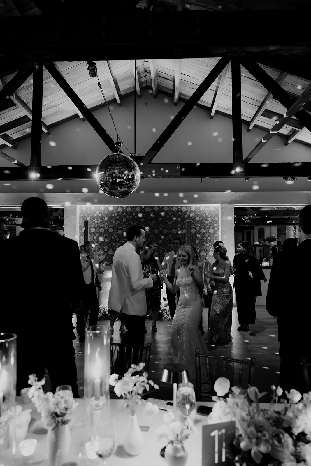 Artsy photo of couple dancing under disco ball at Cannon Green wedding