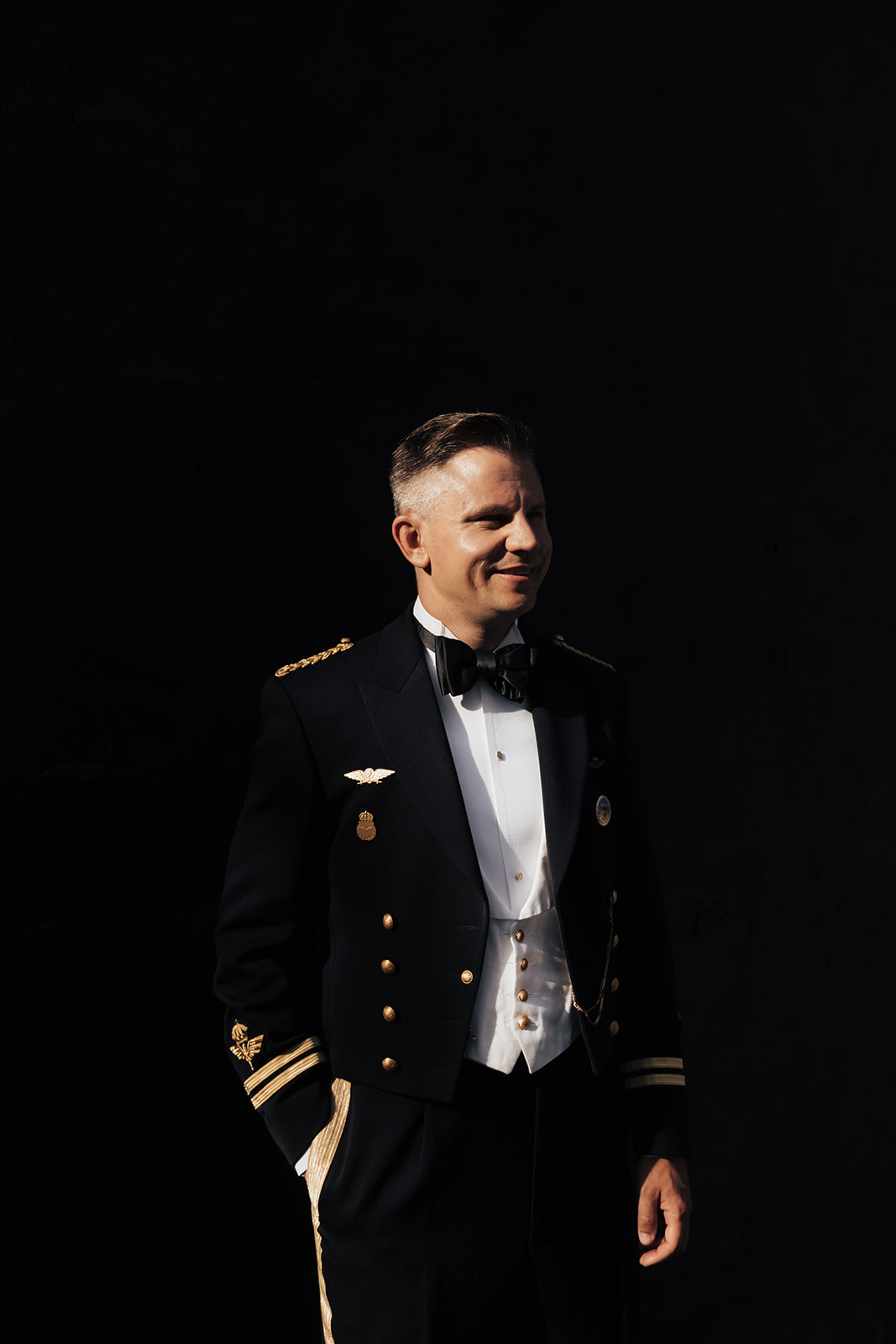 Artful photo of man in military uniform with dark background taken as anniversary photos in Charleston