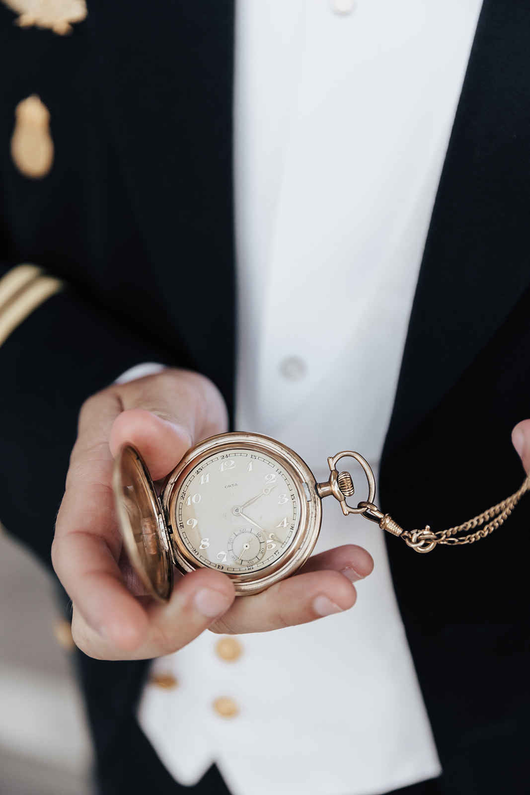 Man showing antique pocket watch into camera
