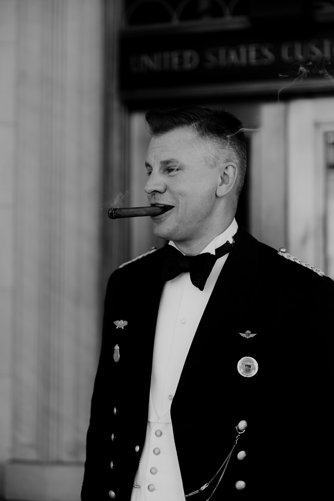 Man in military uniform with cigar in mouth and a little smoke