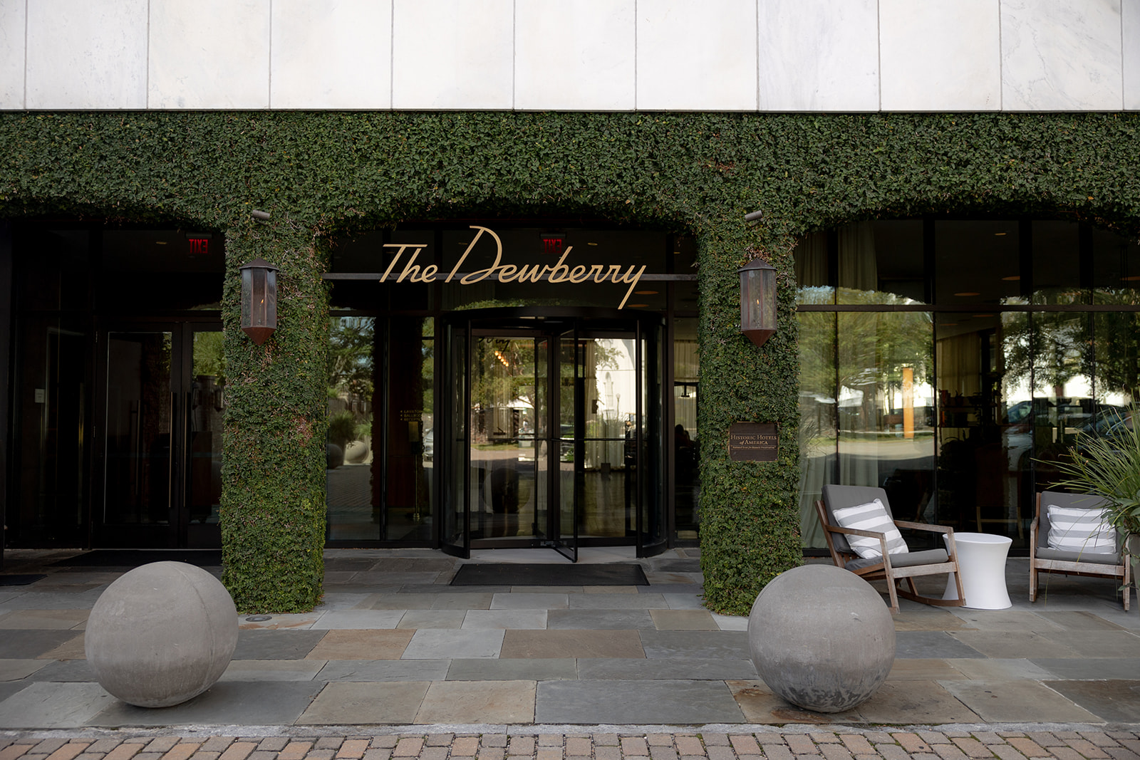 Entrance of the Dewberry hotel with ivy and golden name letters