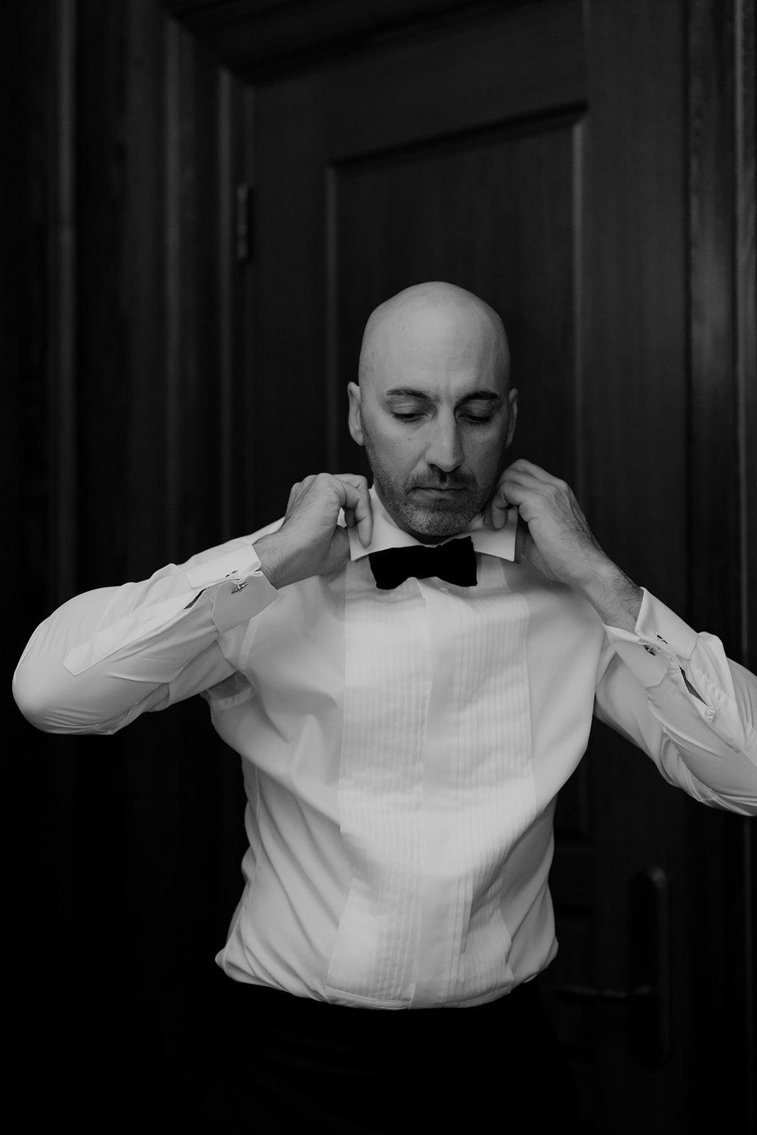 Black and white photo of Groom getting ready at Hotel Bennett