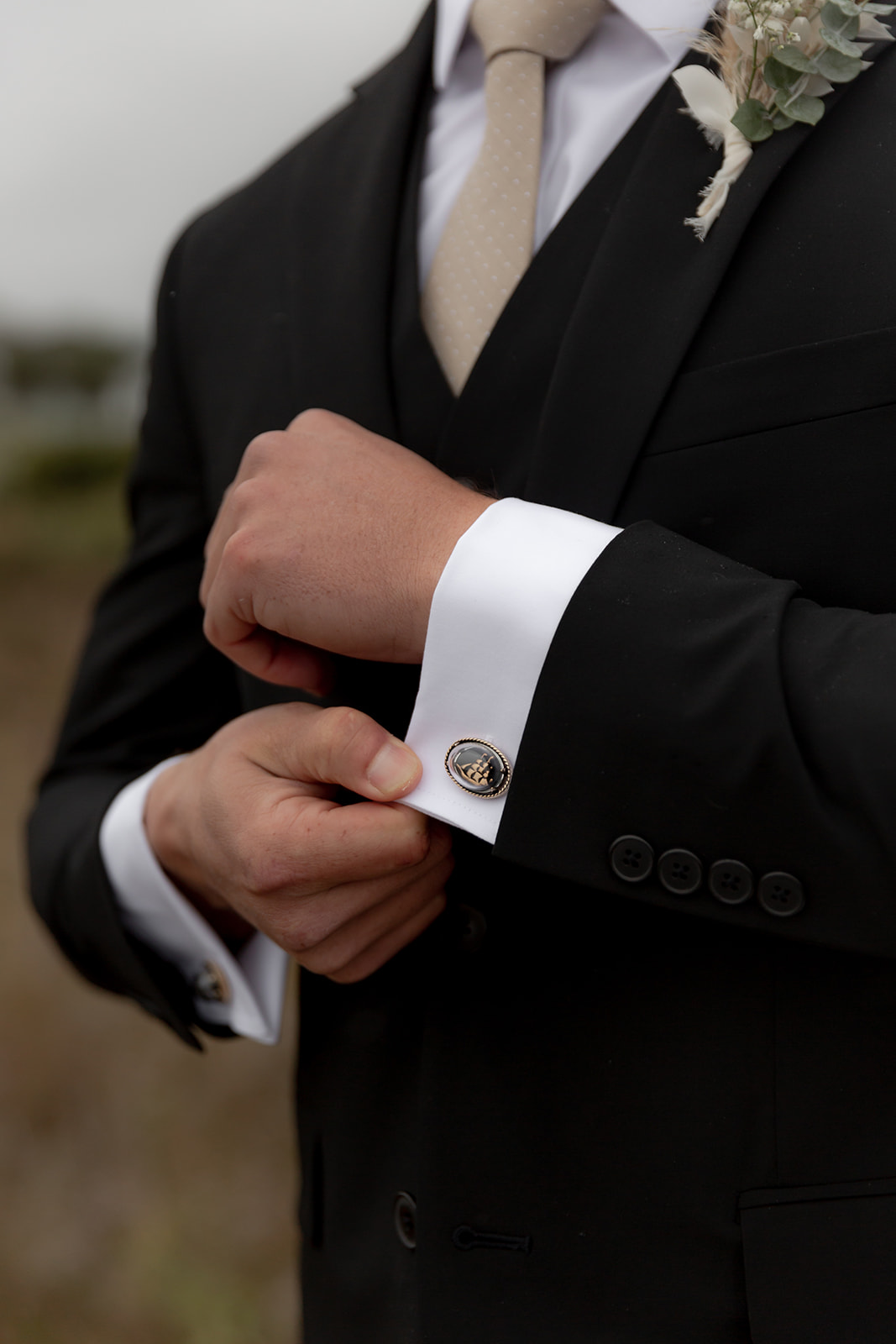 Groom shows cufflinks with Sail boat on hit as homage to his nautical hobbies