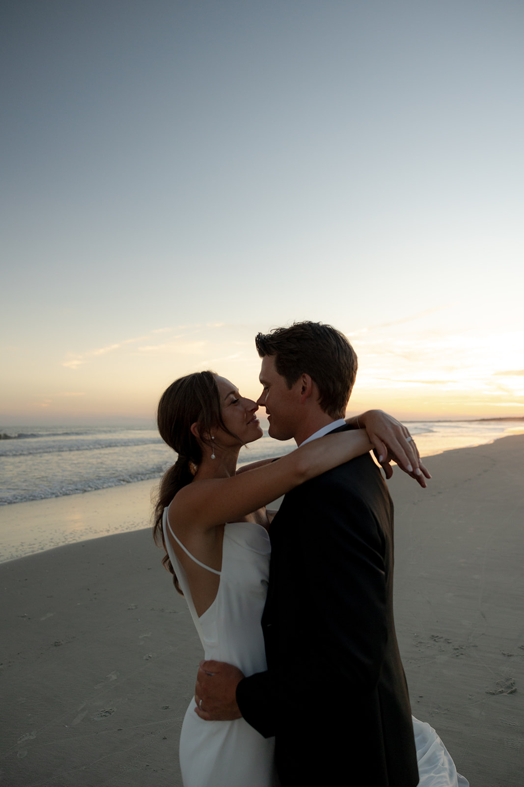 Bride and groom enjoying time at the beach during sunset at Kiawah Ocean Course wedding