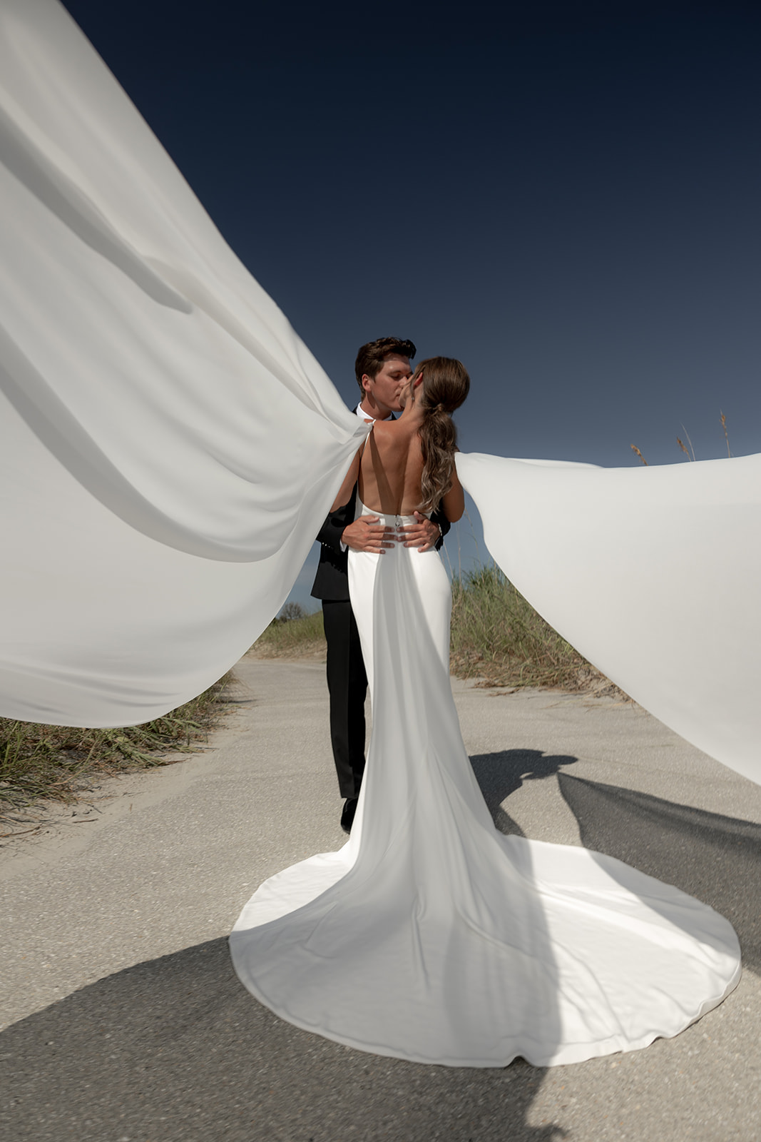 Bride with customized wings at her dress beautifully flowing at Kiawah Ocean Course wedding