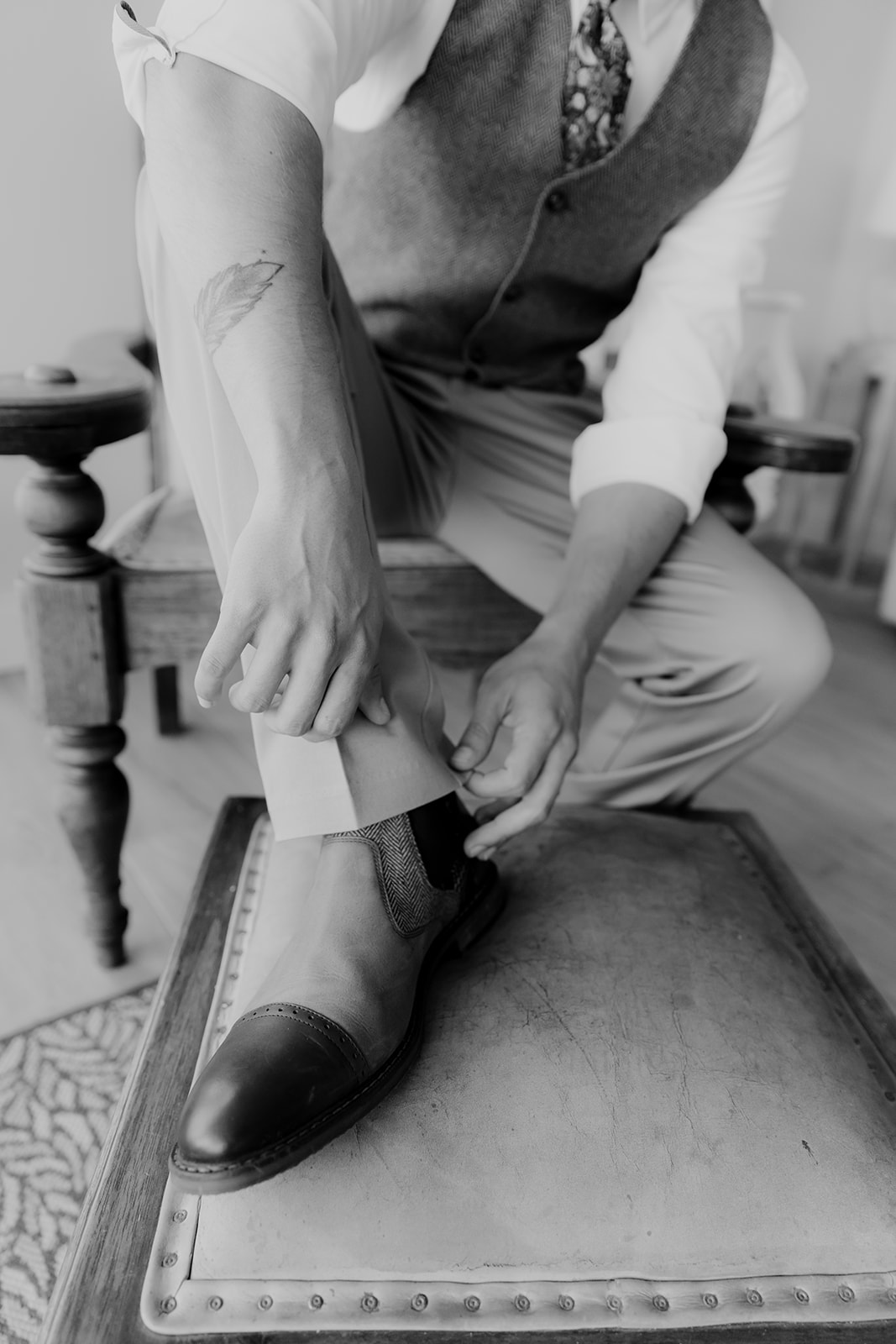 Close up of groom putting on shoes for Ireland elopement