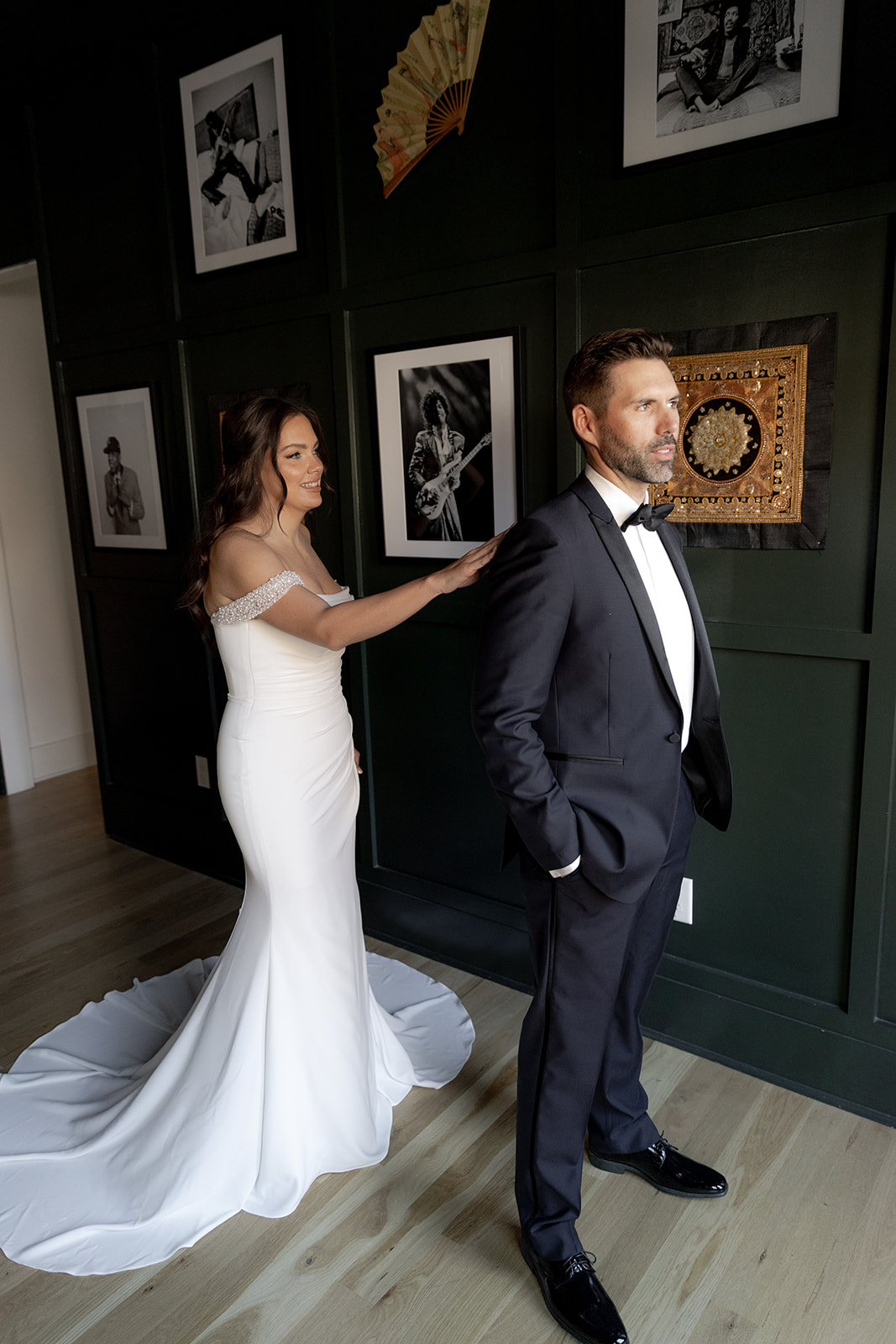 First look between bride and groom at Charleston Elopement in front of picture wall